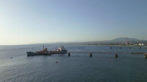 Aerial Perspective of Industrial Cargo Ship Docked at Coastal Pier