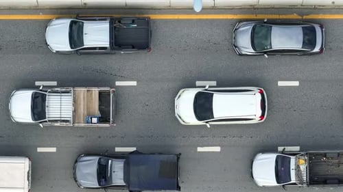 A down view reveals severe traffic jams on a paved city road.