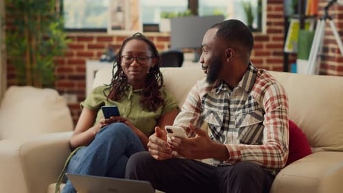 Couple Relaxing at Home with Smartphones
