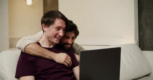 Loving Couple Using Laptop on Couch Together