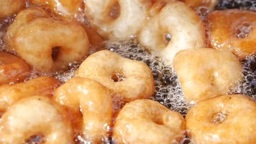 Slow Motion of Traditional Fried Sweets Lokma in Sugar Syrup