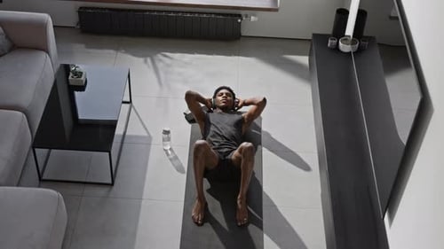 Man Doing Sit-Ups on Exercise Mat at Home