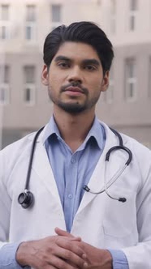 Young Doctor Talking Outside of a Hospital Building