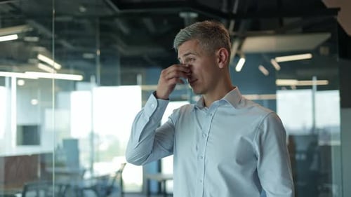 Tired Businessman With a Headache at the Office