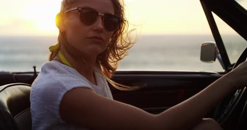 Woman, road trip and sunset at the sea in a car with drive for holiday, adventure
