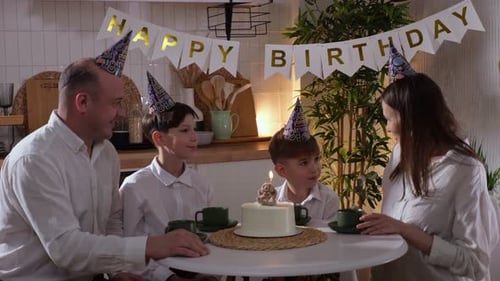 Family Celebrates Birthday with Cake in Cozy Kitchen