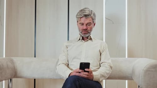 Caucasian Grey Bearded Man in Formal Wear Using Modern Smartphone at Office