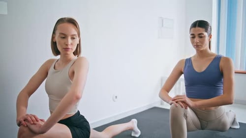 Athletic Women Practicing Stretching Lunges Indoors