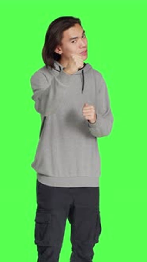 Front View of Young Man Throwing Punches in the Air