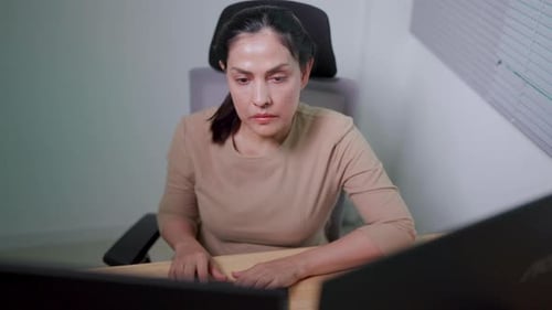 Asian woman working on desktop computer in startup office Experts are coding software for Big Data B