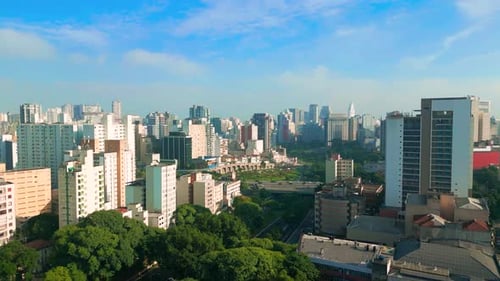 An Aerial View of Sao Paulo Skyline Under a Clear Blue Sky Showcasing Highrise Buildings and Green