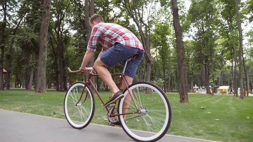 Sporty Guy Cycling at the Park Road Young Handsome Man Riding a Vintage Bicycle Outdoor Healthy