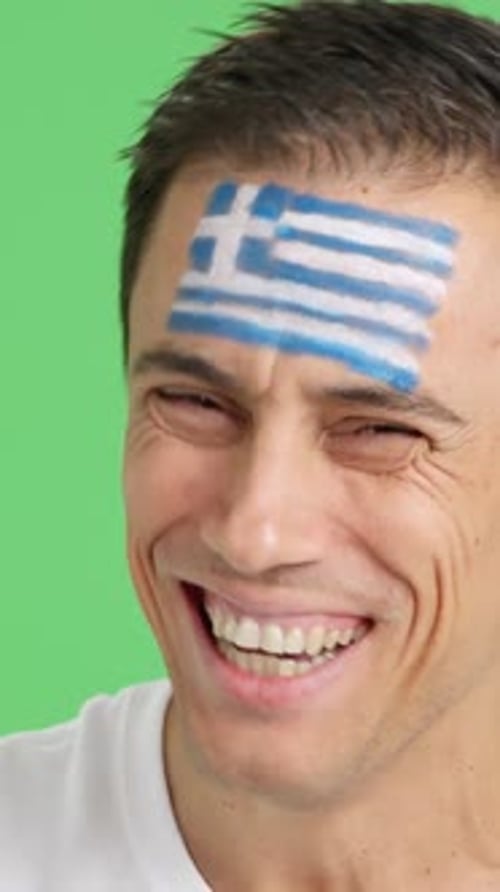 Smiling Man with Greek Flag Painted on Forehead