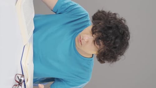 Vertical video of Male student studying.