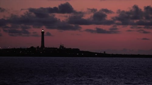 Coastal Lighthouse Silhouette at Dramatic Sunset