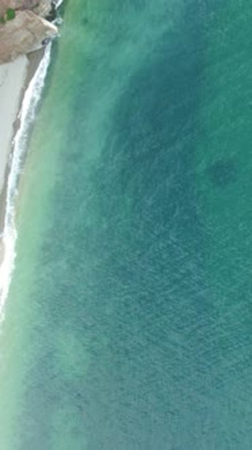 Aerial View on Calm Azure Sea and Volcanic Rocky Shores Small Waves on Water Surface Nature Summer