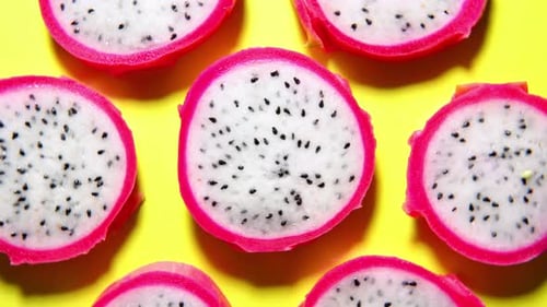 Dragon Fruit Slices on Yellow Background