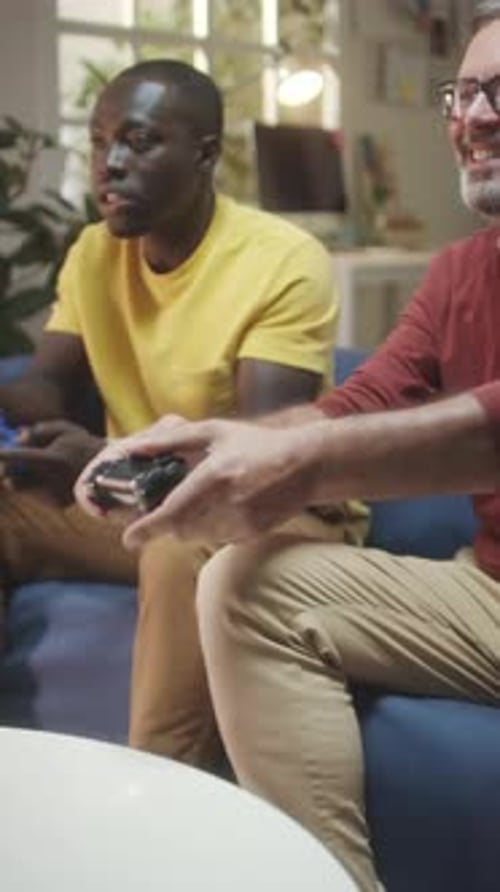 Friends Playing Video Games on Couch Together