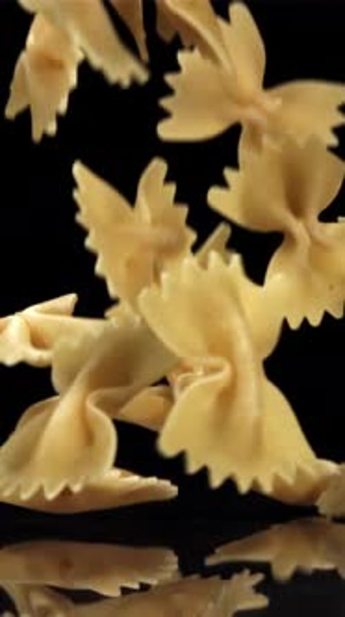Dry Pasta Falls on the Black Table Filmed on a Highspeed Camera at 1000 Fps