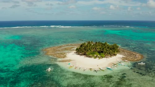 Tropical Guyam Island with a Sandy Beach and Tourists