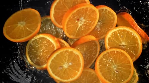 Sliced Orange Circles Fall Into the Water Filmed on a Highspeed Camera at 1000 Fps