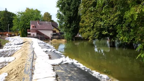 Elevated Sandbag Barrier Protecting Flooded Area Near Homes in a city of Baja, Hungary