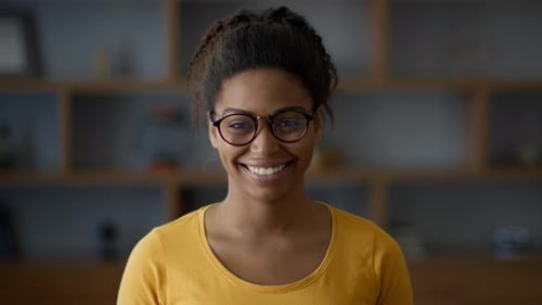 Close Up Portrait of Carefree African American Lady in Eyeglasses Smiling to Camera Posing at Home