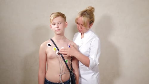Doctor Attaches EKG Leads to Teen's Chest
