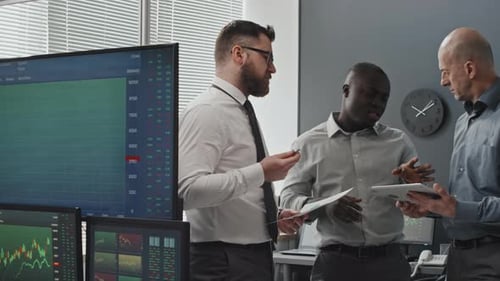 Financial Team Analyzing Charts in Modern Office