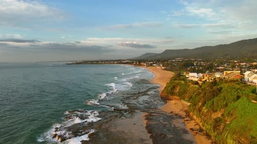 Establishing Dolly of Thirroul Coastline With Crashing Waves and Ocean Road