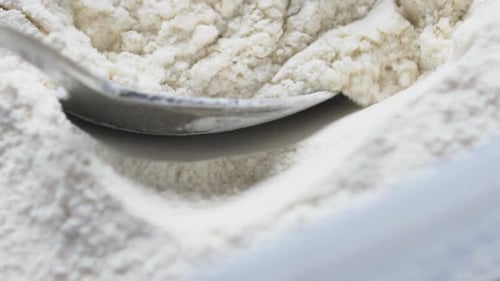 spoon dipped in white flour slow mo