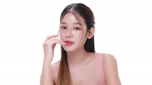 Close up portrait beautiful young Asian woman with healthy facial skin over white background.