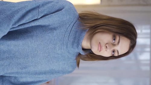 Auburn-Haired Woman Posing Indoors with Blue Sweater