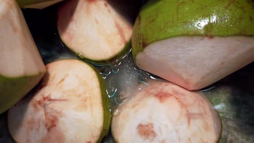 Zooming out from the bucket full of coconut fruit