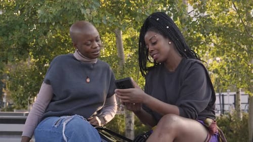 Women Friends Using Smart Phone in Park 10 Seconds or Greater