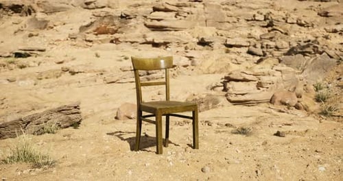 Lonely Chair in a Barren Desert Landscape Under Bright Sunlight