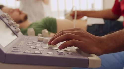 Doctor Performing Ultrasound Scan on Patient at Hospital