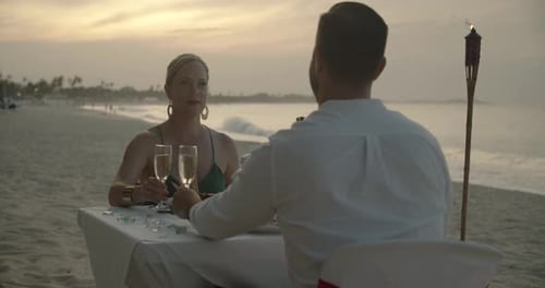 Romantic caribbean wedding dinner on beach at tropical resort sunset