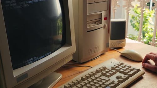 Man Working and Gaming on Retro Computer PC IT Engineer with Vintage Computer at Home Using Old