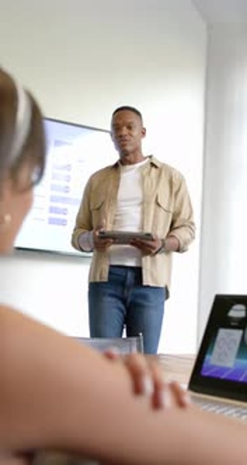 Confident Man Presenting Business Data in Modern Office