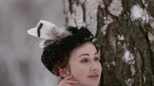 Woman Posing in Vintage Hat in Winter Forest