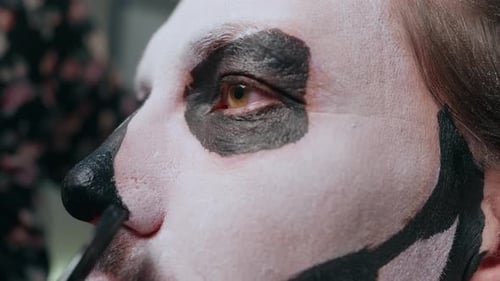 Applying Day of the Dead Skull Makeup with Brush on Face Closeup Detail
