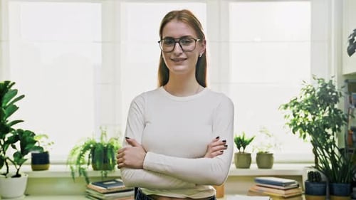 Young Adult Woman with Books and Potted Plants