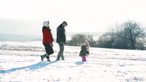 Father and Mother with Their Daughter, Walking in the Snow