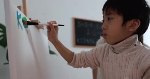 Child Painting on Easel with Brush, Indoor Art