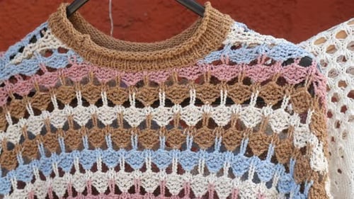 Colorful Crochet Sweater Display in a Local Artisan Market
