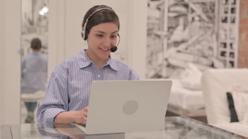 Young Indian Woman with Headset Talking with Customers Online in Call Center
