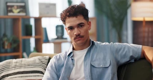 Young Adult Relaxing on Couch Indoors