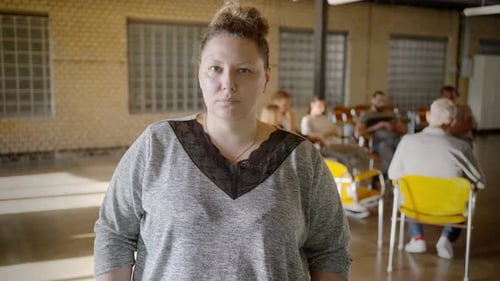 Lady Standing Aside Mental Health Group in Community Center