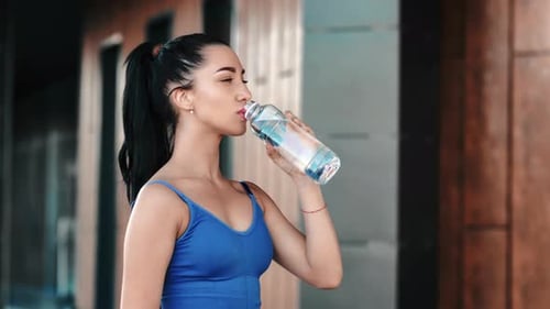 Beautiful Fitness Woman Smiling Drinking Pure Refreshment Water From Bottle Outdoor City Building